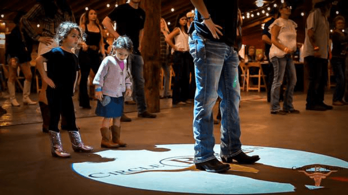 Families two-stepping on the Circle R dance floor