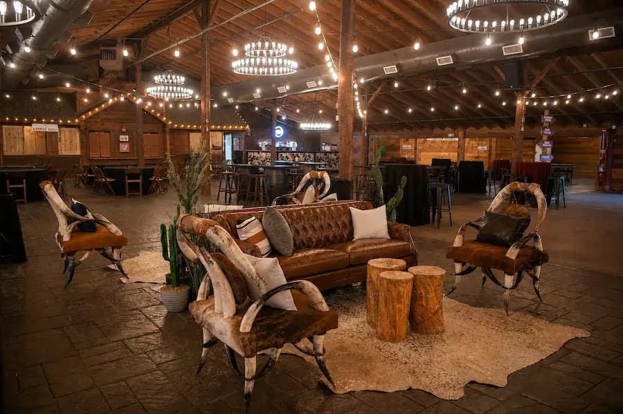 Cowhide lounge seating under chandeliers inside the pavilion